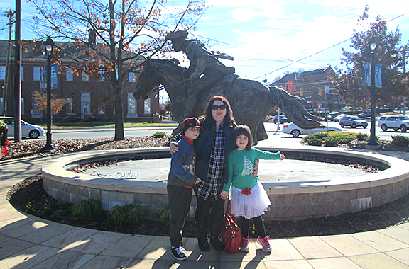 Amanda Bergen with her children Alex and Catherine in front of the Captain Jack statue in Charlotte