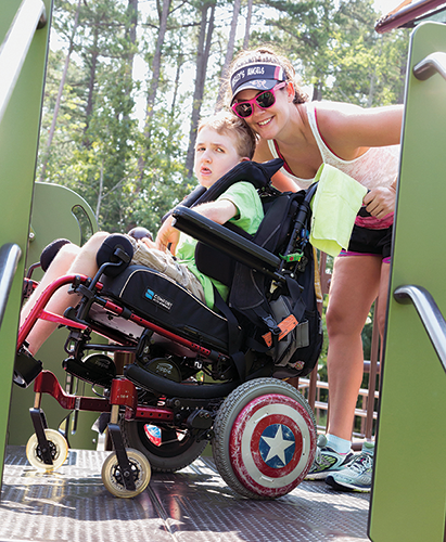 Parent and child with I/DD on accessible playground