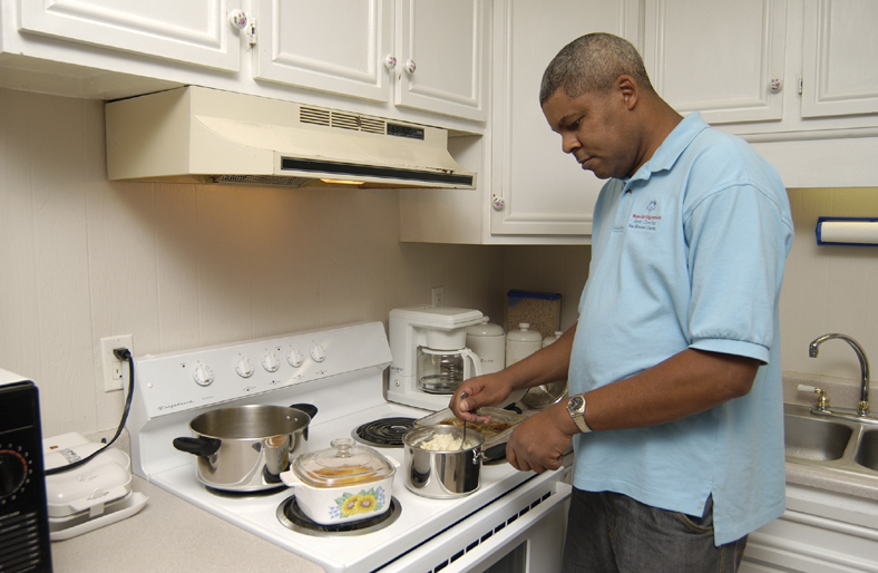 person with a disability making dinner 