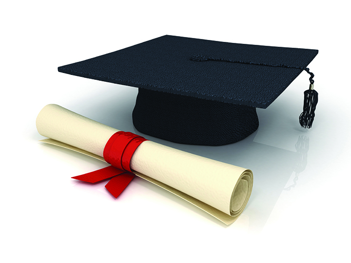 A graduation cap and a diploma rolled up with a red ribbon